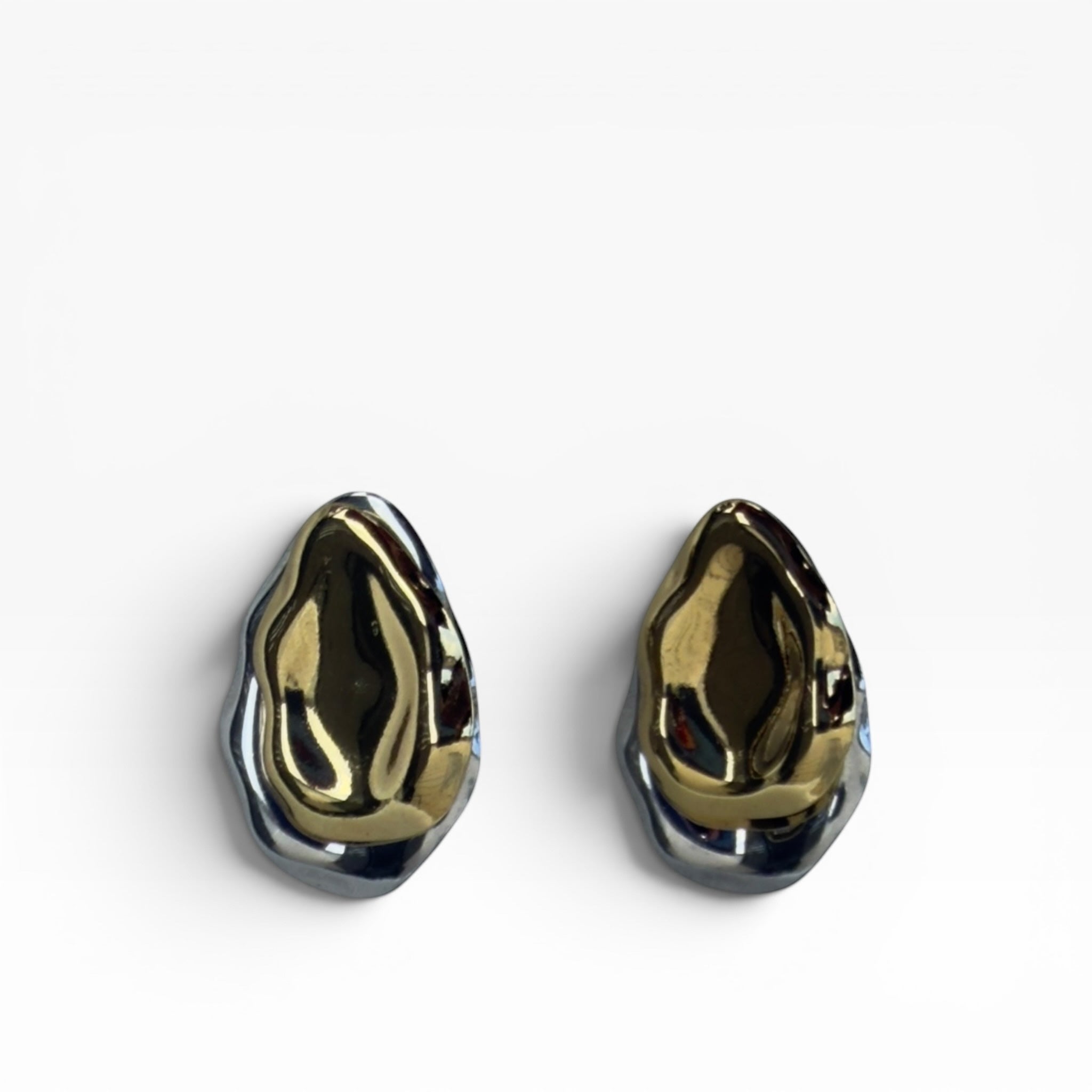 TALI abstract sculptural statement earrings featuring a dual-tone gold and silver molten metal organic design.