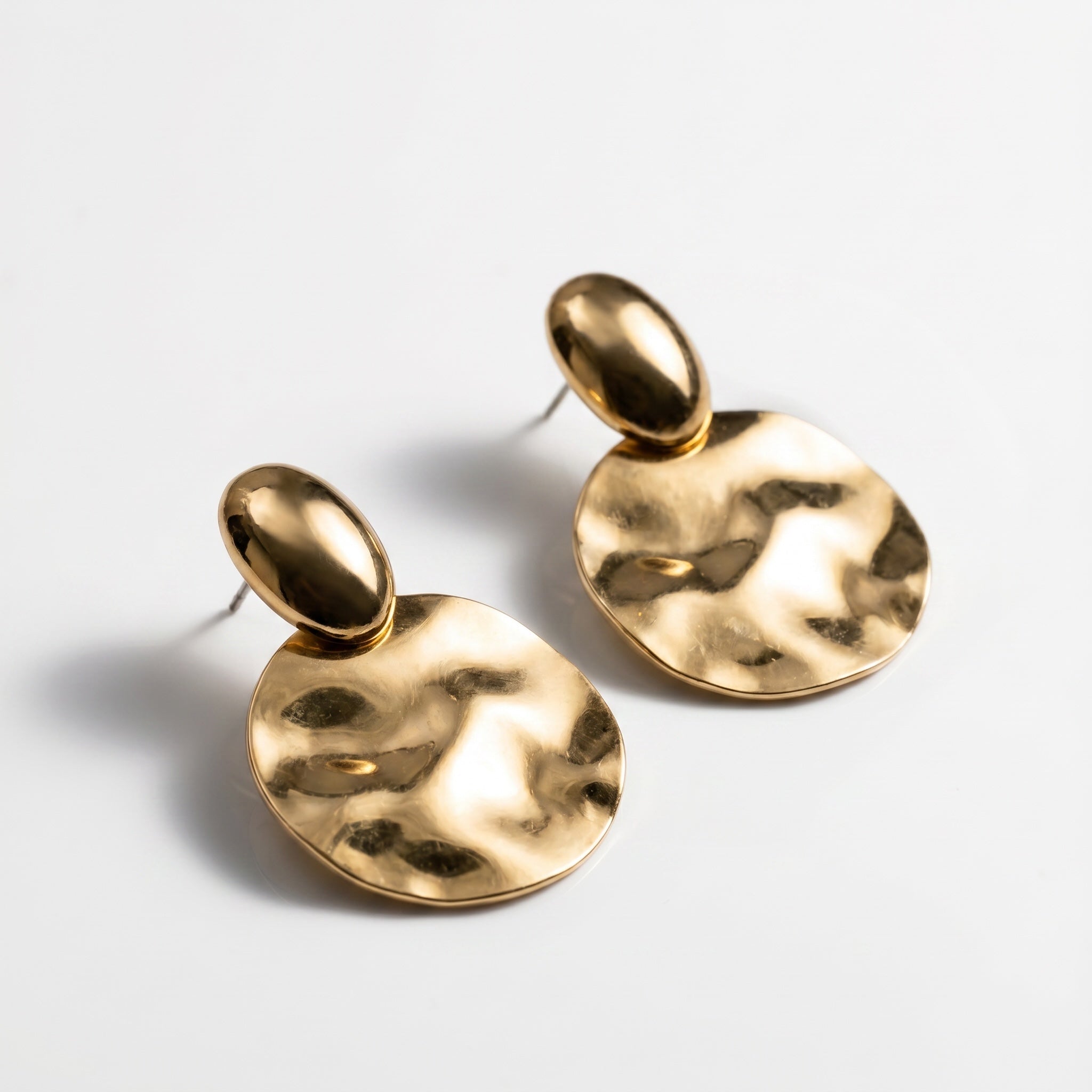 TALI gold-tone statement earrings with a smooth stud top and a large, hammered-texture circular drop.
