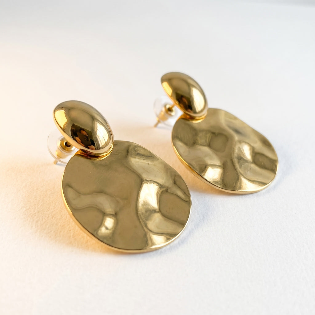 TALI gold-tone statement earrings featuring a polished stud and a large, hammered-texture circular drop.