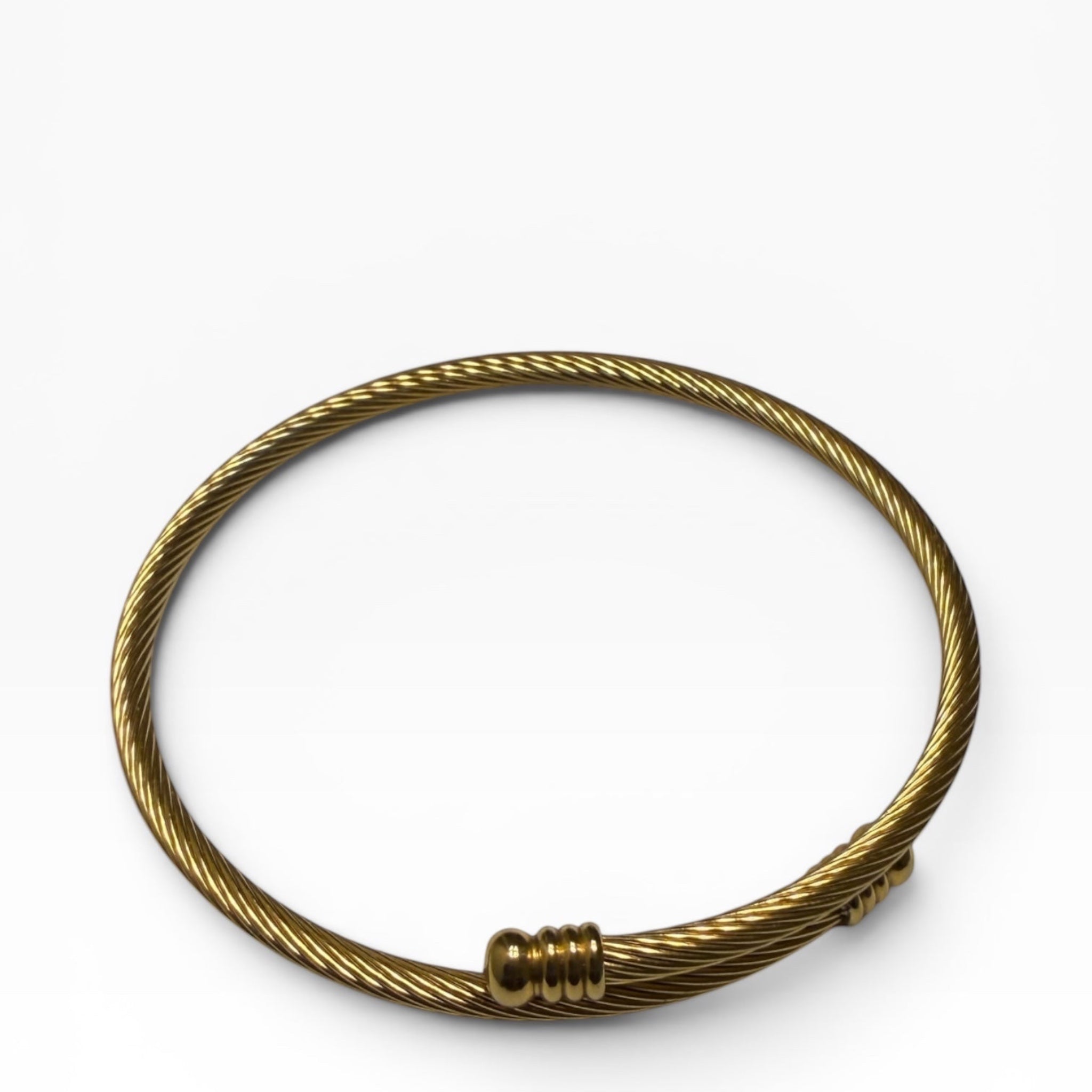 TALI gold-tone twisted wire cable bangle bracelet with polished ribbed end caps on a white background.