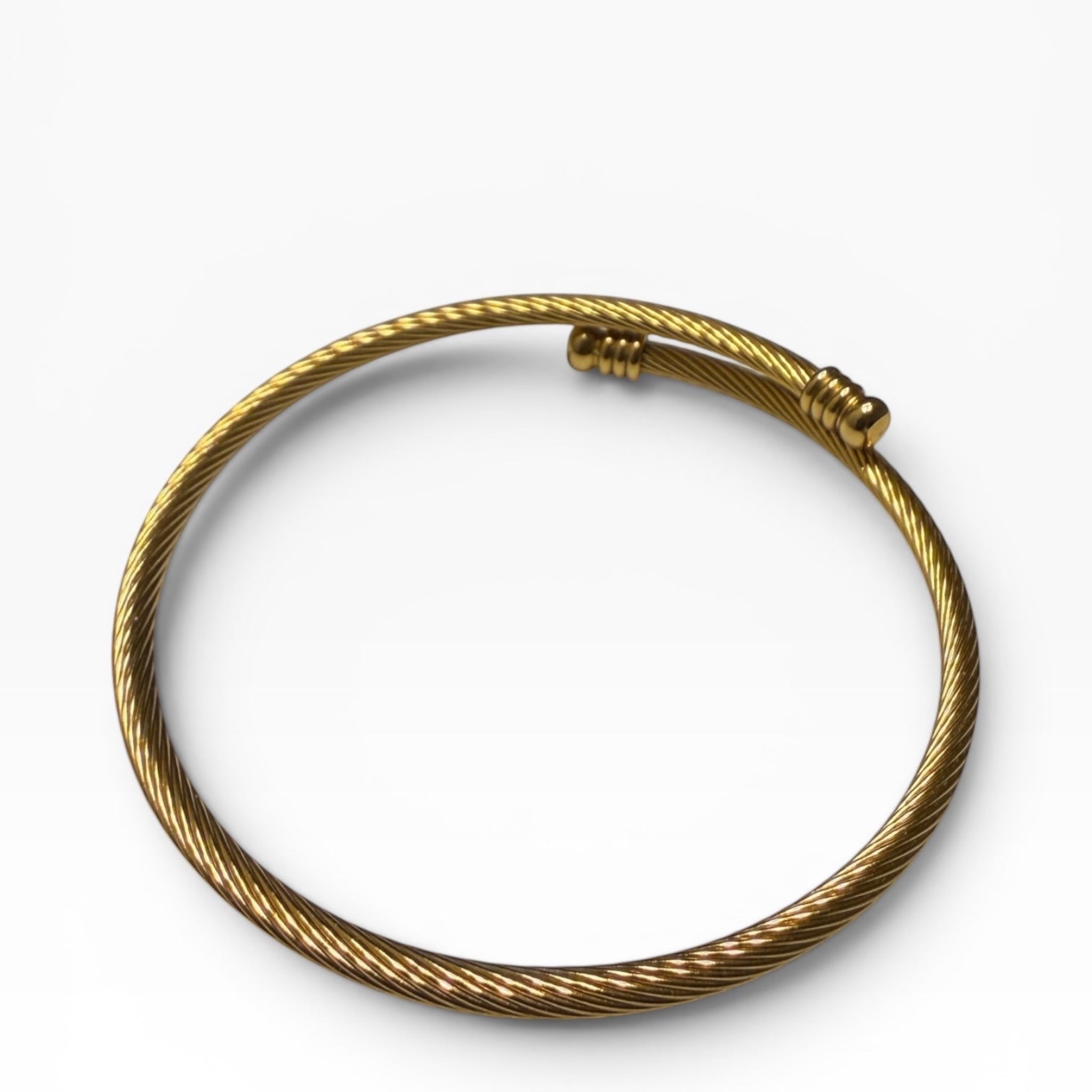 TALI gold-tone twisted wire cable bangle bracelet with polished ribbed end caps on a white background
