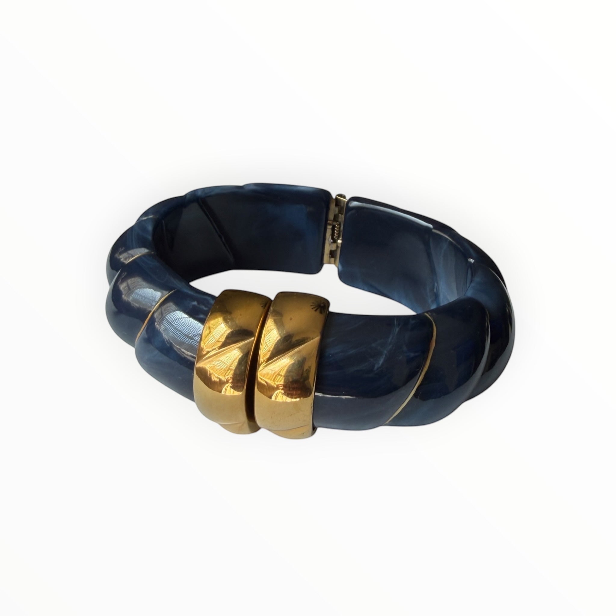 TALI The Riviera Resin Bracelet in navy blue marble with gold plated accents and a hinged clasp design.