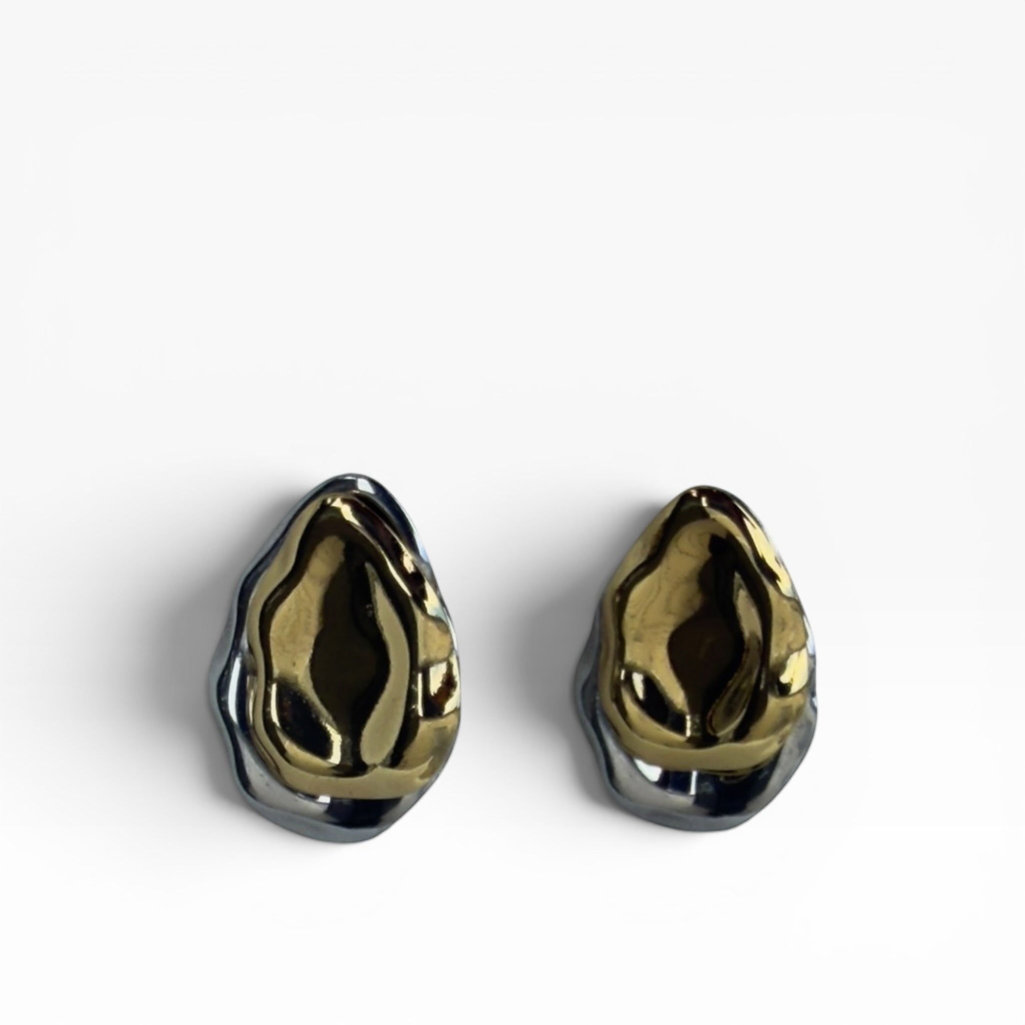 TALI sculptural statement earrings featuring organic, molten-style gold and silver dual-tone metallic contours.