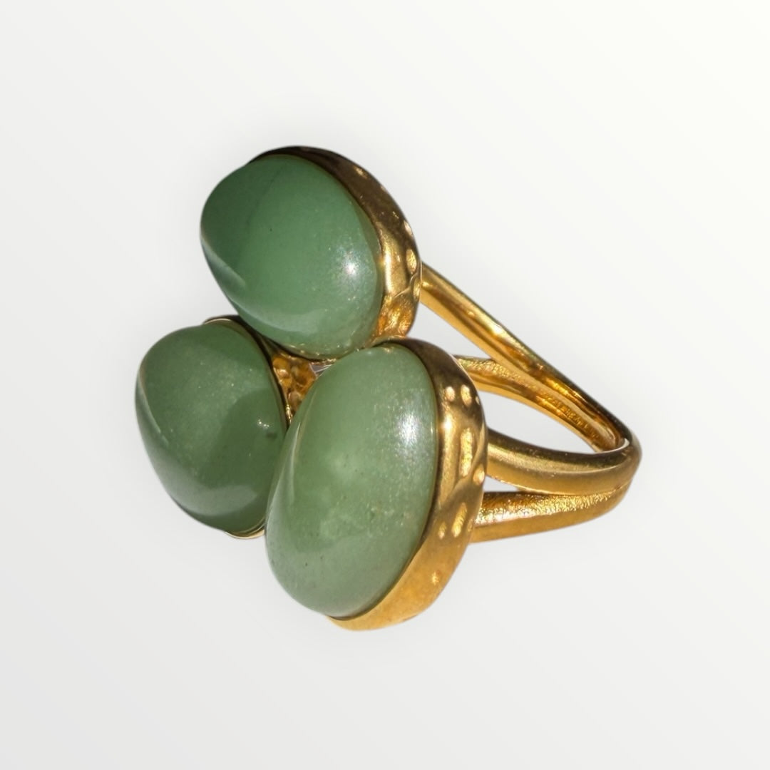 TALI triple oval green cabochon stone statement ring with a gold-toned hammered metal band on a white background.