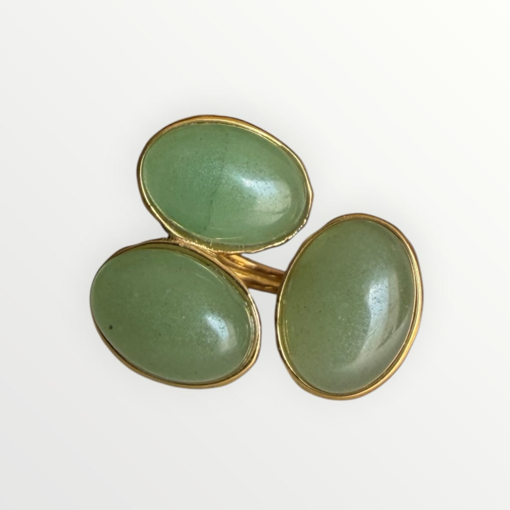 TALI triple oval green cabochon stone statement ring in a gold-toned hammered metal setting.