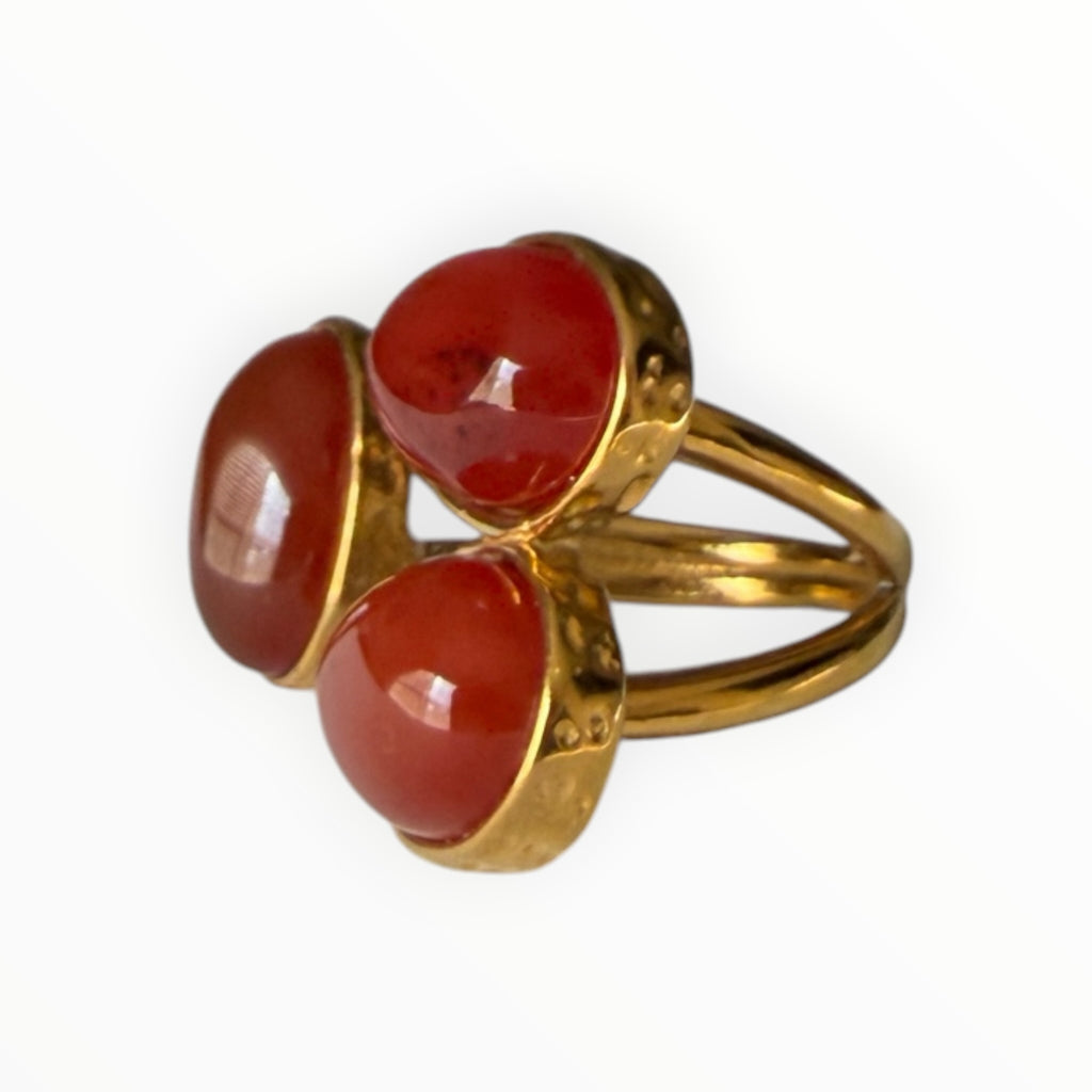 TALI triple oval red cabochon stone statement ring in a gold-toned hammered metal setting with a split-shank band.