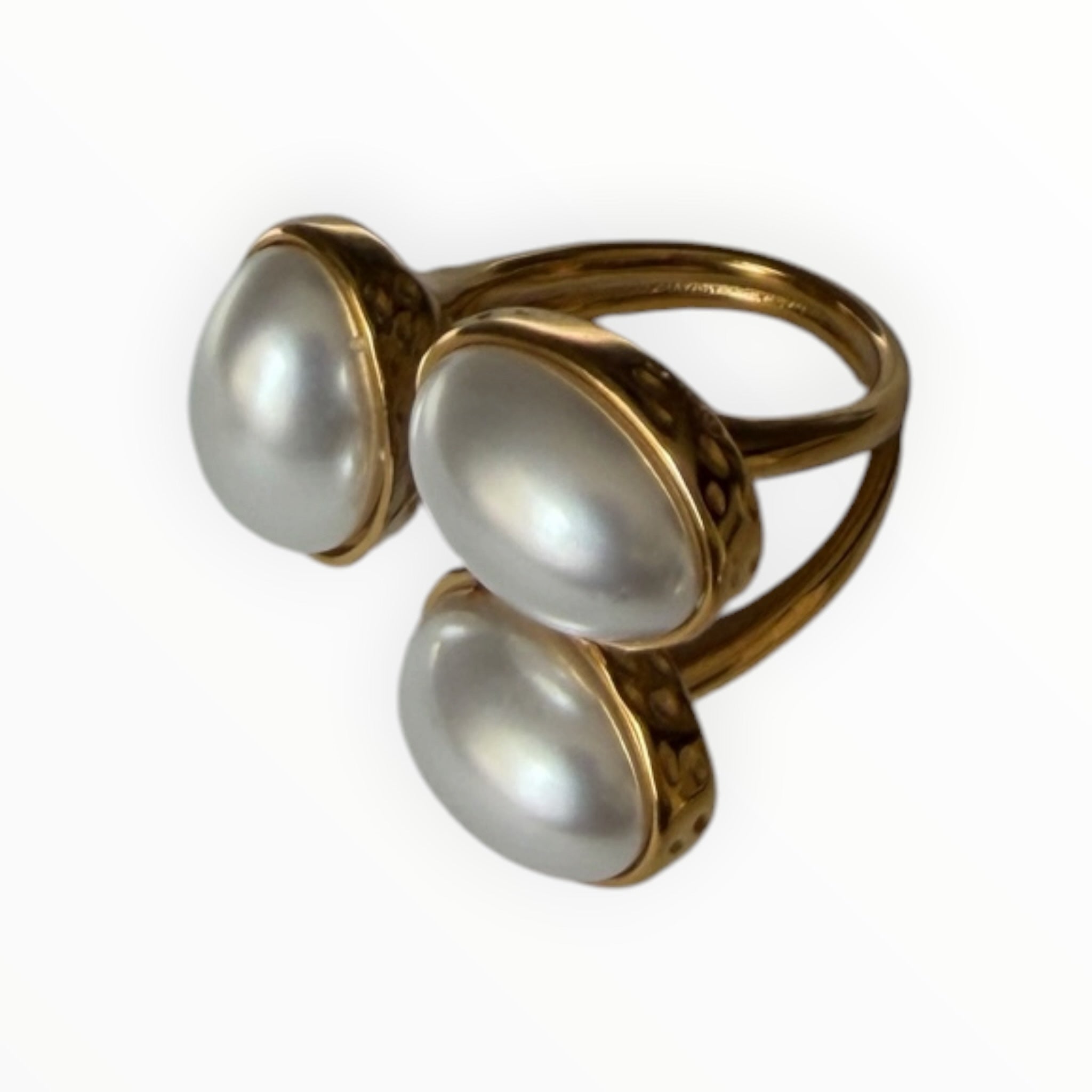 TALI triple oval stone statement ring featuring white cabochons in a hammered gold-tone split-shank setting.