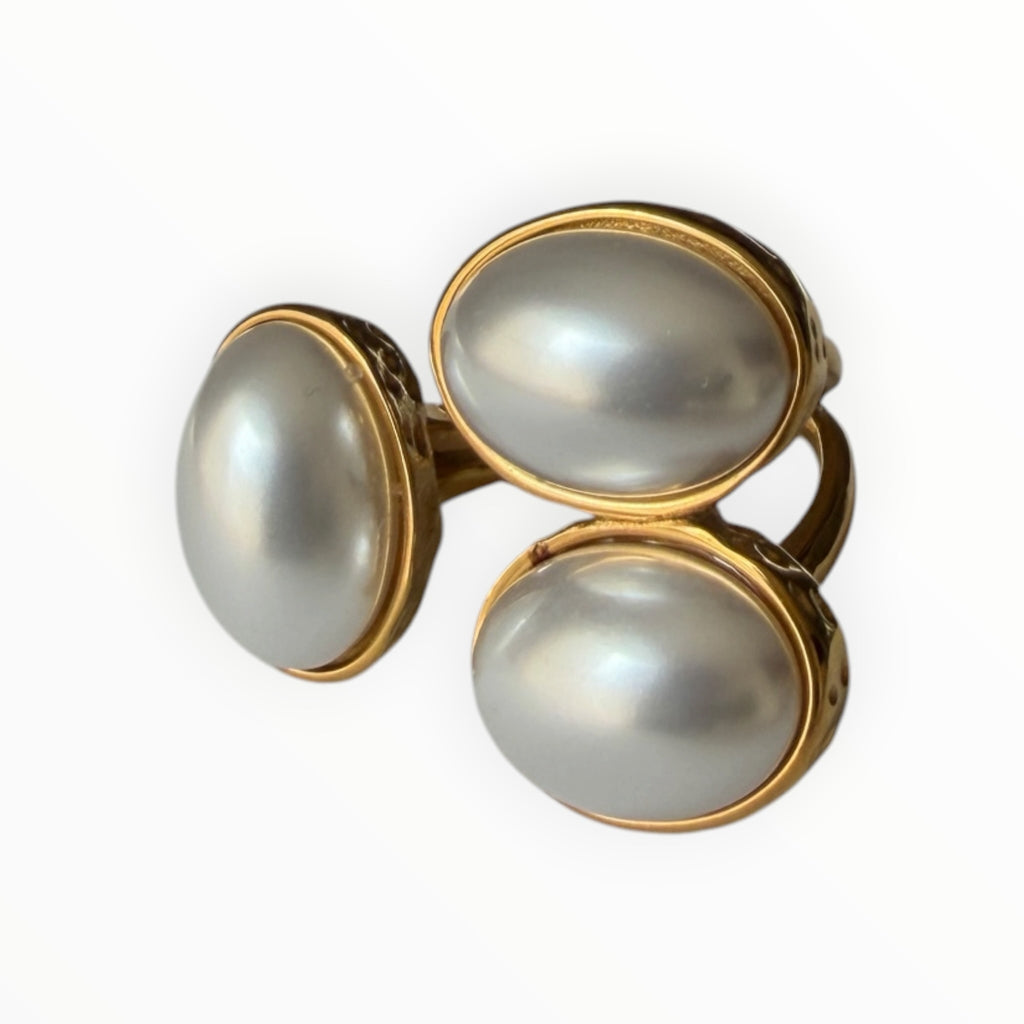 TALI triple oval stone statement ring featuring three smooth cabochon stones in a hammered gold-toned metal setting.