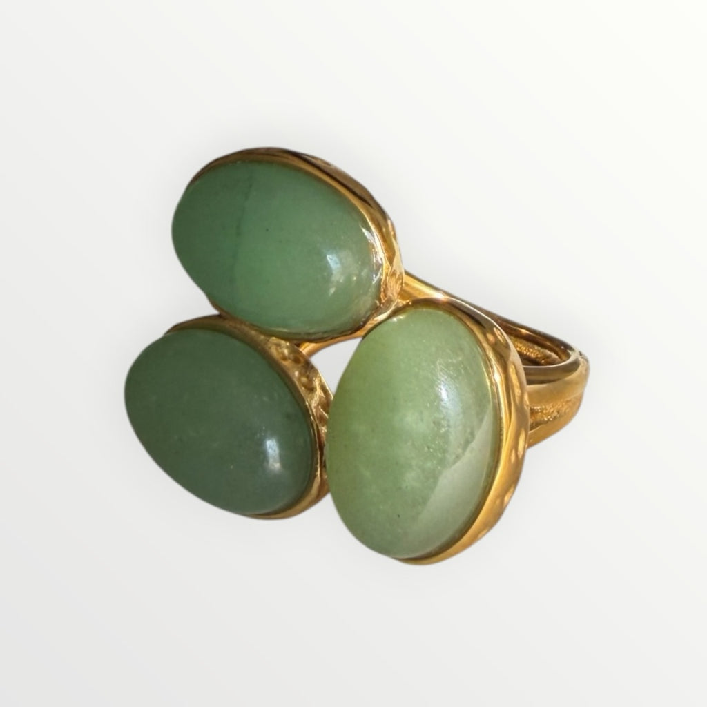 TALI statement ring featuring three smooth green oval cabochon stones set in a hammered gold-toned metal frame.