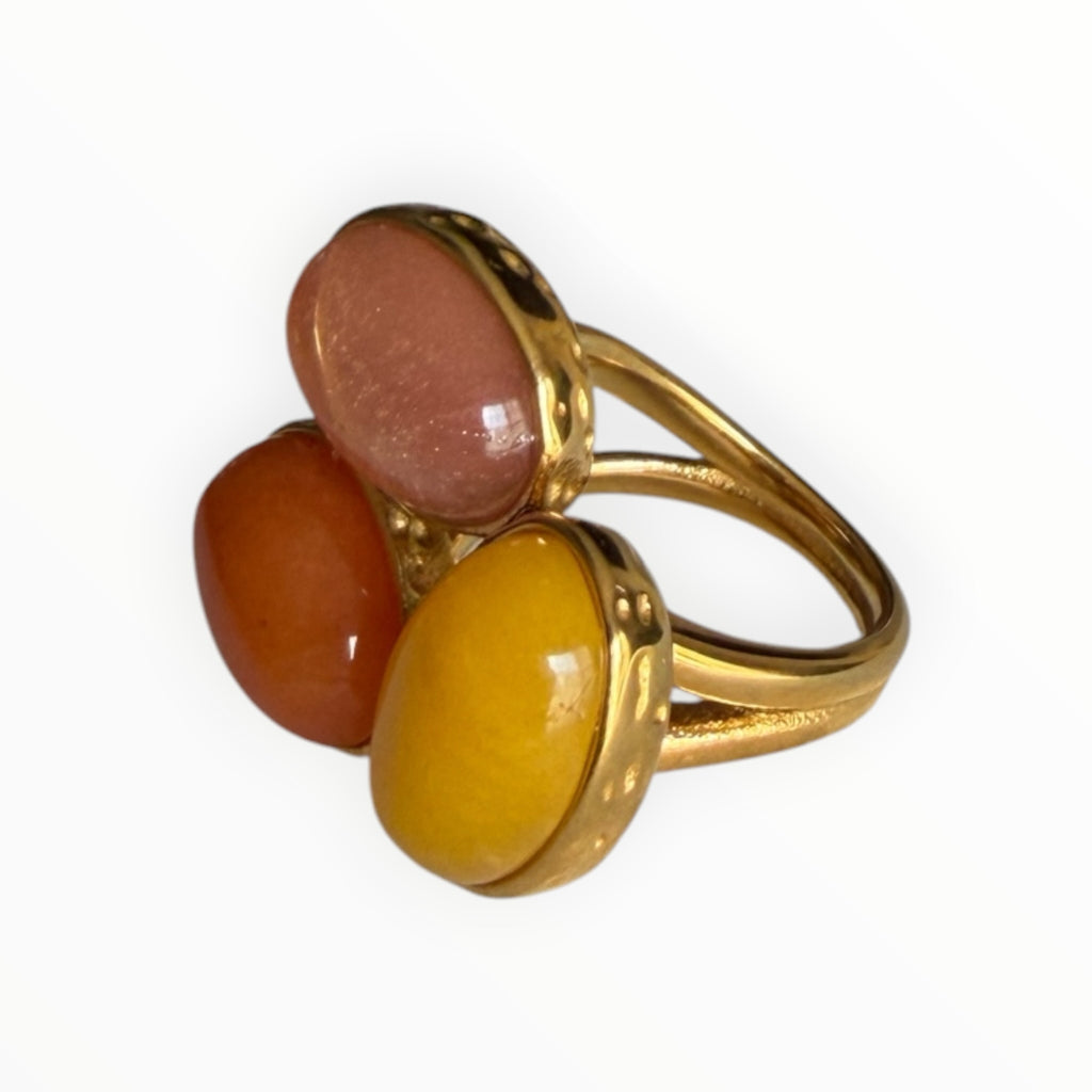 TALI triple oval stone statement ring featuring multi-colored cabochon stones in a hammered gold-toned metal setting.