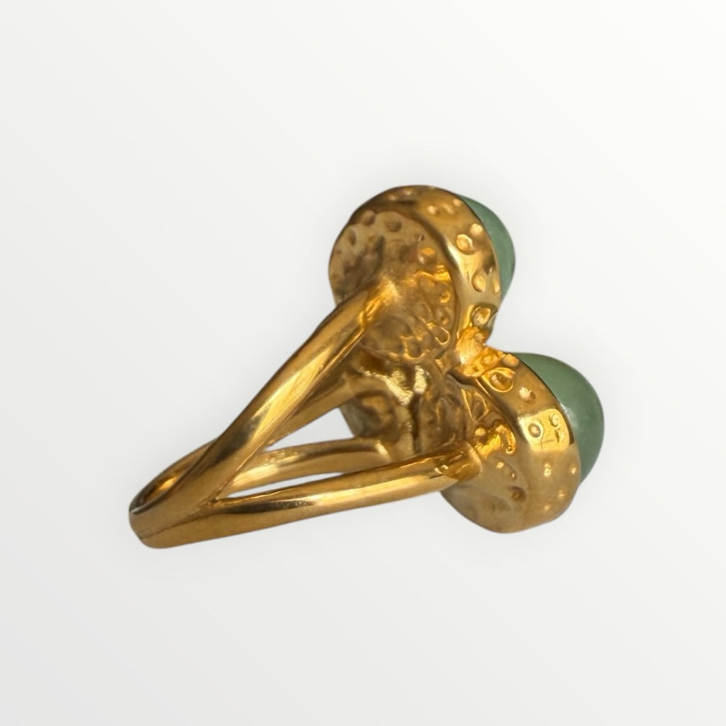 TALI gold-toned statement ring featuring three oval green cabochon stones with a hammered metal split-shank band.
