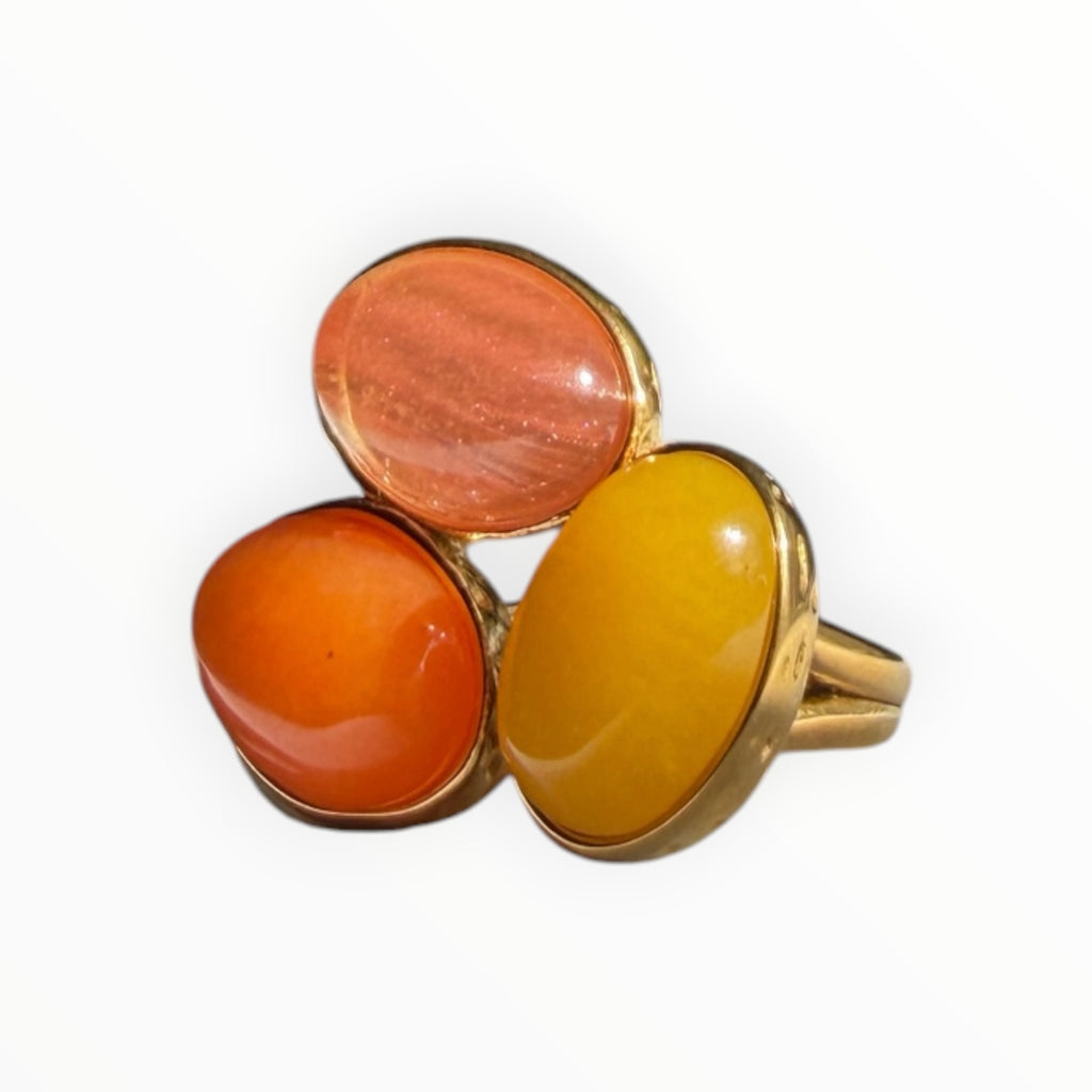 TALI triple oval stone statement ring featuring orange, yellow, and peach cabochons in a hammered gold-toned setting.