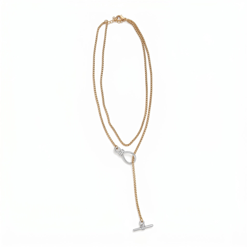 TALI two-tone lariat necklace featuring a gold chain with a silver knot centerpiece and toggle bar closure.
